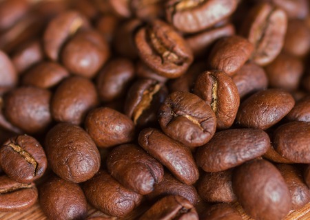 Closeup of coffee beans with focus on one