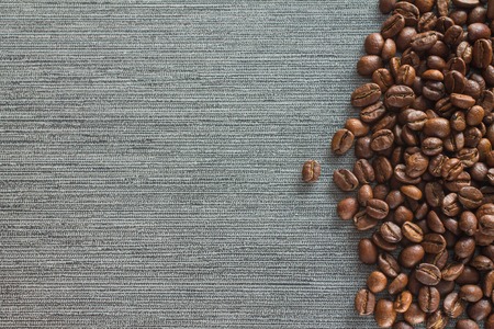 Coffee beans on grey tile background, copy spaceの写真素材