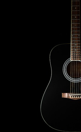 Classical black guitar on a black background with copy space. Isolatedの写真素材