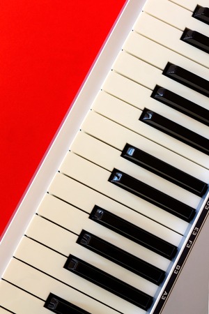 Top view on digital piano keyboard on the red bacgroundの写真素材