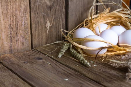 White eggs from with a straw on tableの写真素材