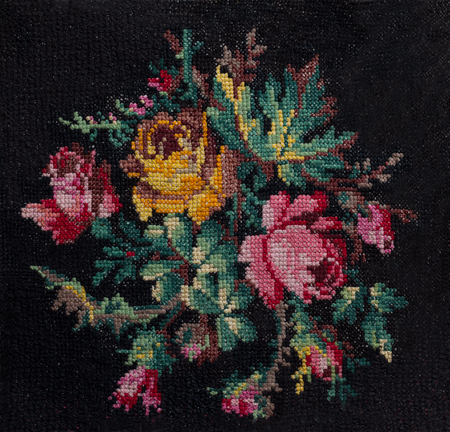Cross-stitch the bouquet of roses and leafs on black background.の写真素材