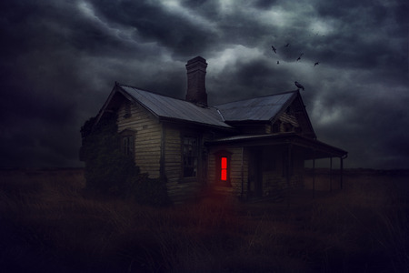 Illustration of a magic dilapidated house at night with bright red glowing windows and crows circling at home.の写真素材
