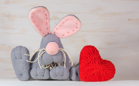 Soft toy rabbit with heart. St. Valentine Day conceptの写真素材
