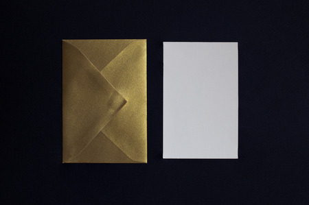 card invitation and golden envelopeの写真素材