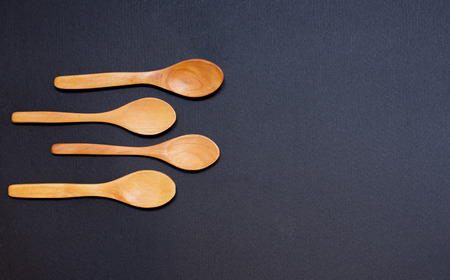 Wooden spoons on dark backgroundの写真素材