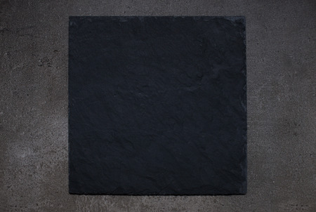 Black tray board on gray stone backgroundの写真素材