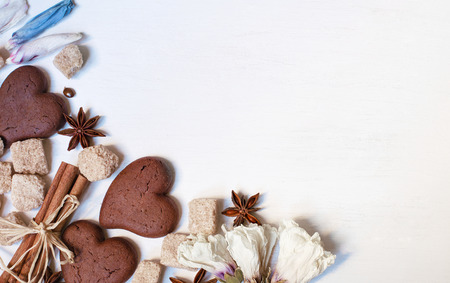 Chocolate cookies, brown sugar, anisetree and cinnamon on white wooden backgroundの写真素材