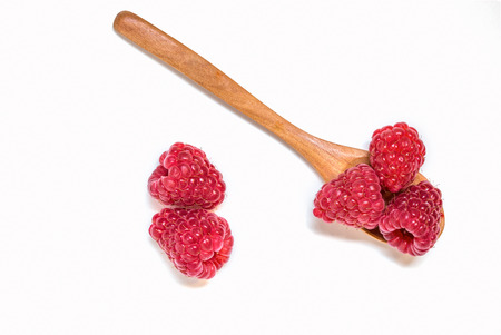 Two wooden spoons with raspberry. Isolatedの写真素材