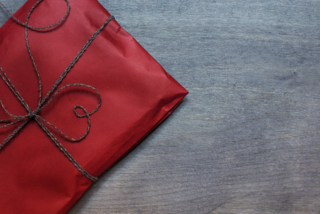 Red present pack on wooden background. Top viewの写真素材