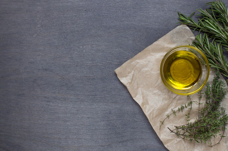 Some herb and olive oil on wooden background. Top viewの写真素材