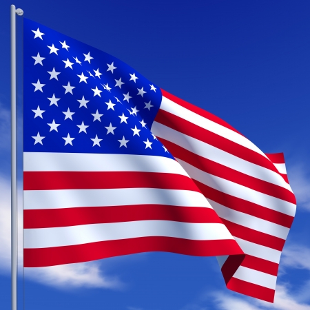 The American flag flies on a background of blue skyの写真素材
