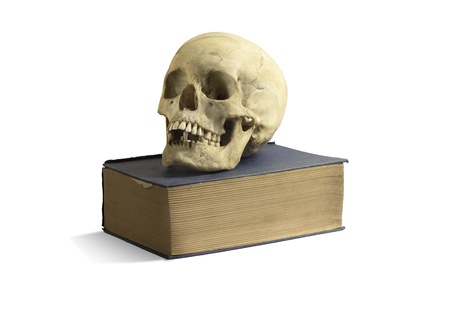 An old skull on top of an old bookの写真素材