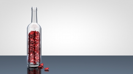 Symbolic glass bottle with many of red hearts inside. の写真素材