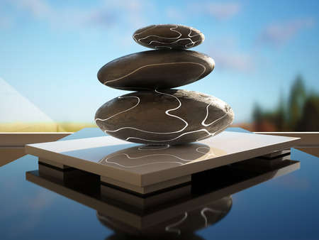 Three zen stones one above the other in front of a windowの写真素材