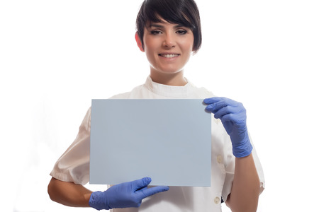 Female doctor smiles and holding a labelの写真素材