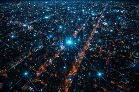 Aerial view of a vibrant city at night, connected by illuminated networks, showing modern data connectivity and urban infrastructure.の素材