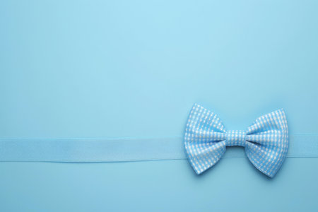 This festive concept features a bow tie against a blue pastel background for Fathers Day.の素材