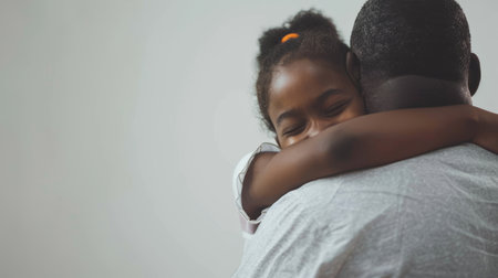 White background with an isolated girl hugging her fatherの素材