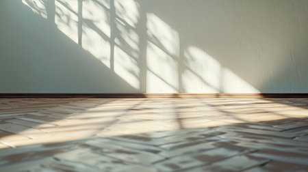 An empty room with a wood laminate floor and shadows cast on the wall from the sun. Perspective of minimal interior design. 3D rendering.の写真素材