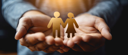 A paper family is pictured holding a family insurance policyの素材