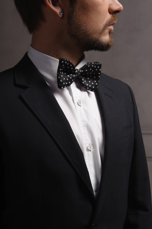 young Caucasian dark hair man with a beard  in suitの写真素材