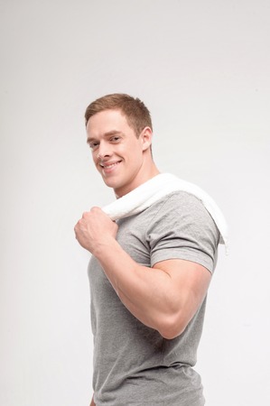 Waist up  portrait of a handsome  happy man after workout isolated on whiteの写真素材