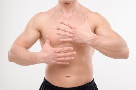 Close up portrait of strong masculine torso with handsの写真素材