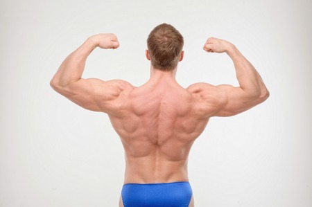 Man with perfect athletic body, bodybuilder,  biceps isolated on white  Concept of bodybuildingの写真素材