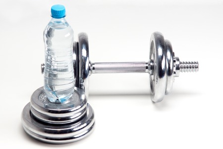 Chrome Weights dumbbells with bottle of water, isolated on white backgroundの写真素材