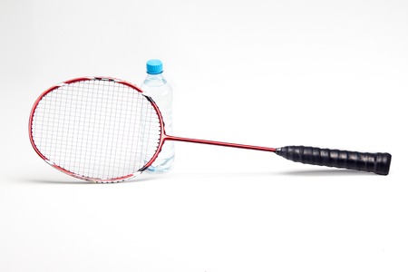 Water bottle behind badminton racket isolated on white backgroundの写真素材
