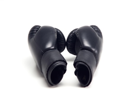 Pair of black boxing gloves isolated on white backgroundの写真素材