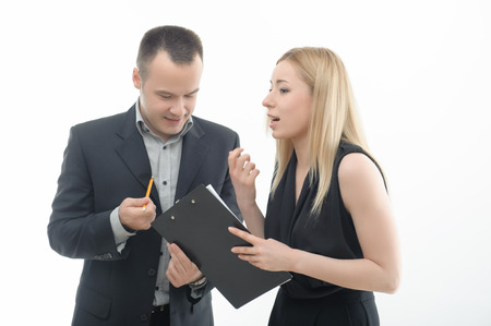 Colleagues young man and attractive blond woman discussing something, isolated on whiteの写真素材