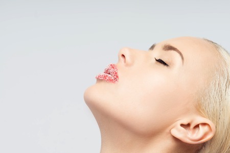 Closeup portrait of sexual passionate beautiful blonde with sugar lips isolated on a white background  Emotions, cosmetics conceptの写真素材