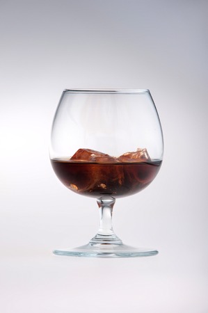 Whisky glass with ice on white background