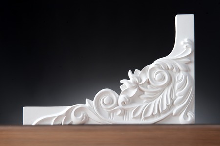 Beautiful elements of luxury wall design, white stucco mouldings over dark background, antique plastering の写真素材