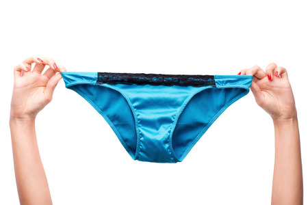 Woman hand holding blue lingerie. Isolated on white backgroundの写真素材