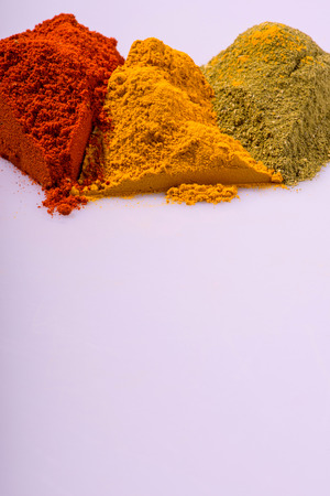 Composition of  various ground  different colorful  spices heaps like paprika oregano  cardamom  isolated on white background with copy spaceの写真素材