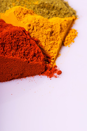 Composition of  various ground  different colorful  spices heaps like paprika oregano  cardamom  isolated on white background with copy spaceの写真素材