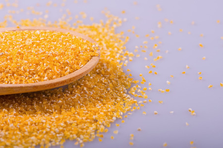 Composition of spoon with maize isolated on white background with copy place selective focusの写真素材