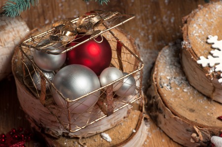 Christmas and New Year decoration  like wooden logs and white snowflakes  and red or  silver  ball in box on wooden tableの写真素材