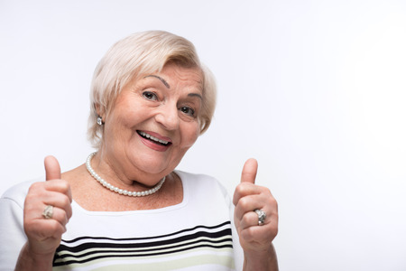 Elderly lady showing her thumbs up