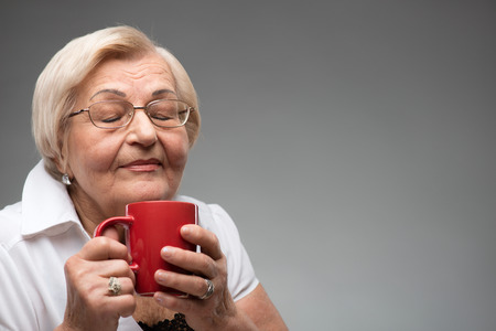 Elderly woman with cup of coffeeの写真素材