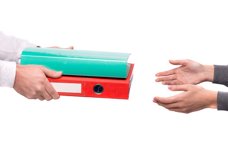 Hand giving folders to other person