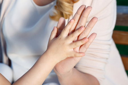 Funny game. Close up portrait of mother and daughter playing patting cake.の写真素材