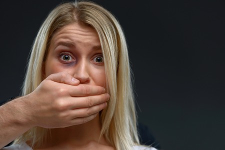 Do not do it. Close up of beaten young depressed girl expressing fear and being punished by a man...