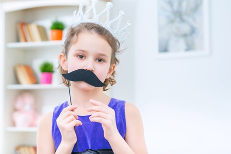 Lets play. Pleasant pretty girl expressing positivity while playing at homeの写真素材