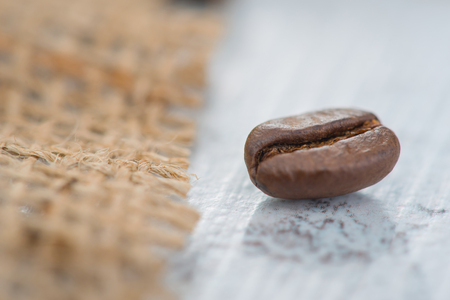 Nice product. Close up of coffee bean lying on the table surface.の写真素材