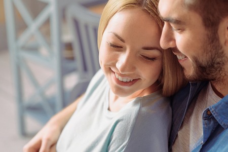 We are the one. Positive young romantic couple smiling and bonding to each other while feeling happyの写真素材