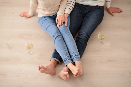Find inspiration. Top view of pleasant loving couple holding hands of each other and sitting on the...